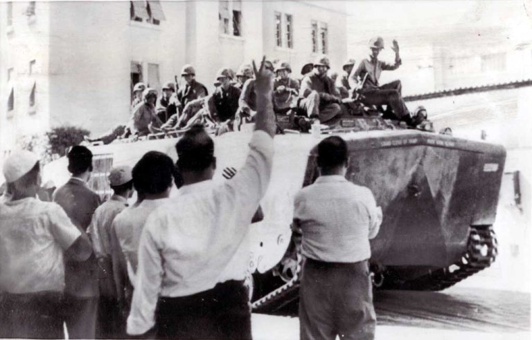 Lebanese people greeting a USMC LVTP-5 entering Beirut.
