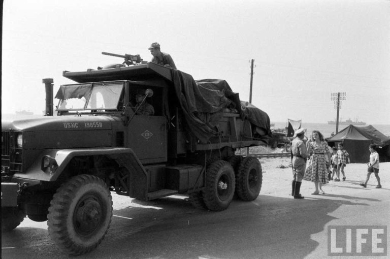 A USMC M51 Dump truck on a coastal road.