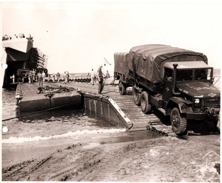 Navy Seabees offloading USMC M35 cargo trucks and equipment in Lebanon, 1958